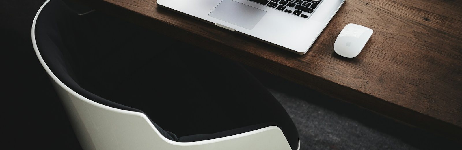 Apple MacBook beside computer mouse on table