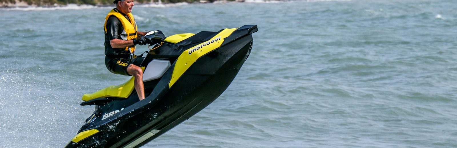 man riding personal watercraft