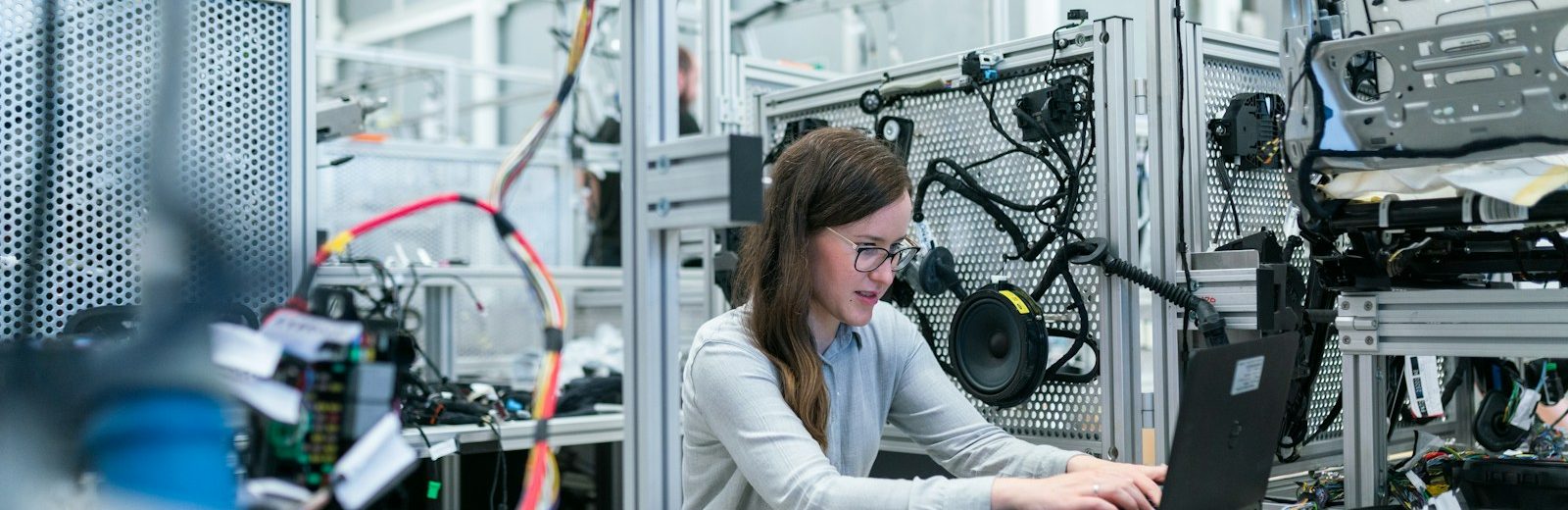 woman in white long sleeve shirt using black laptop computer